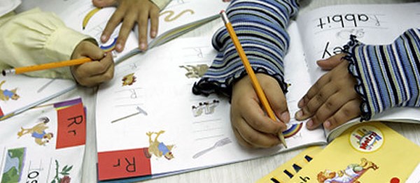 Children drawing in books