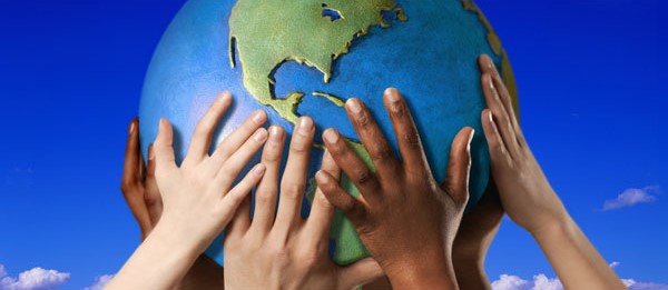 Children hands holding planet earth.